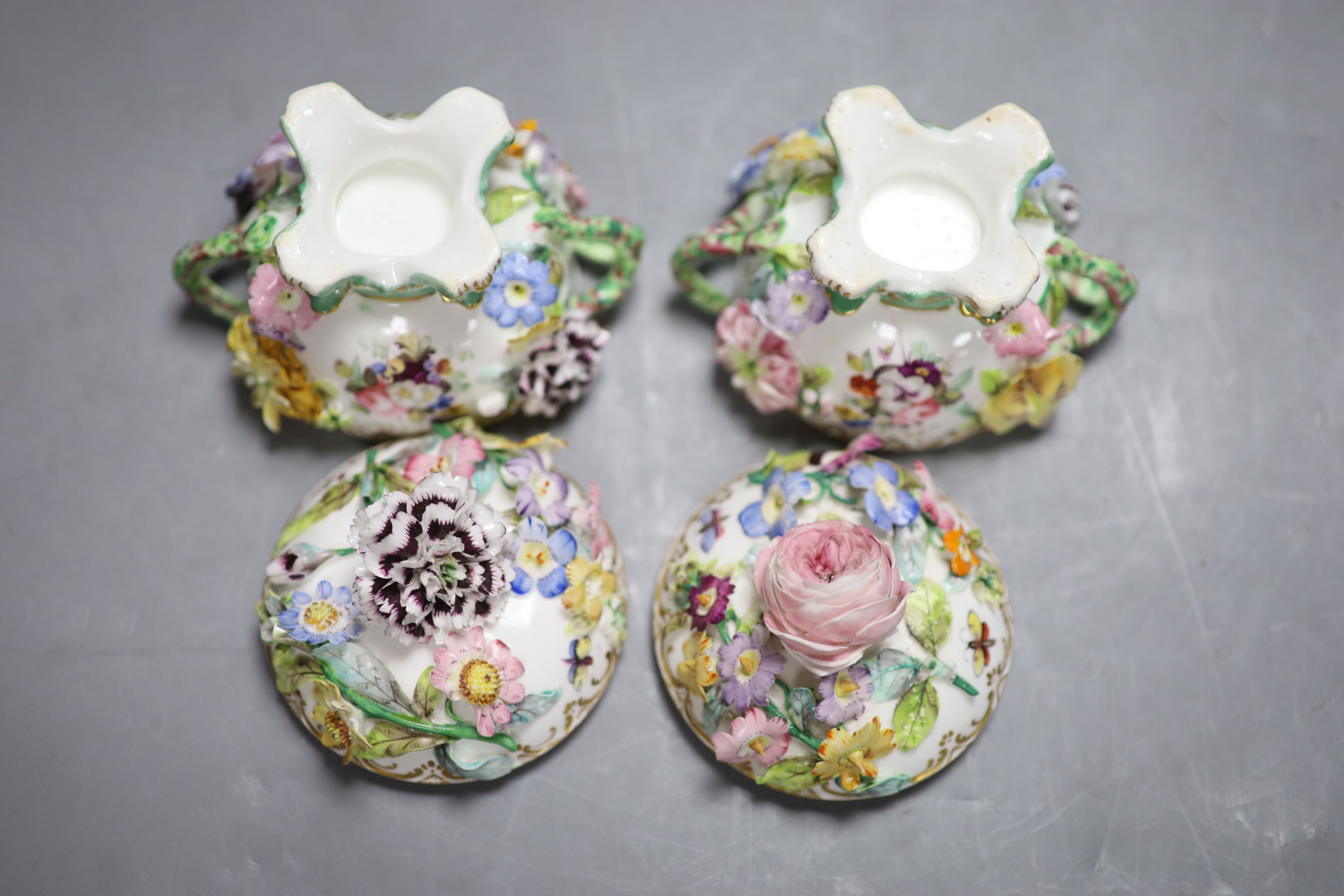 A mid 19th century Coalport pair of floral encrusted two handled cups and covers